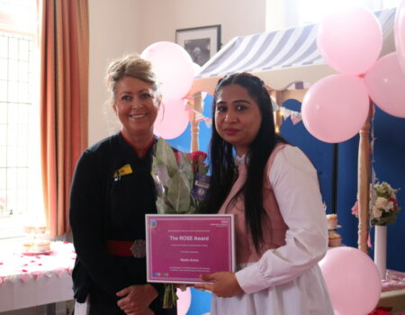 Liz awarding Neetu with the ROSE runner up