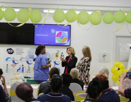 Natalie receives her sculpture from Deb