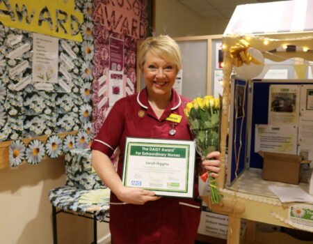 Sarah with her DAISY Award and flowers