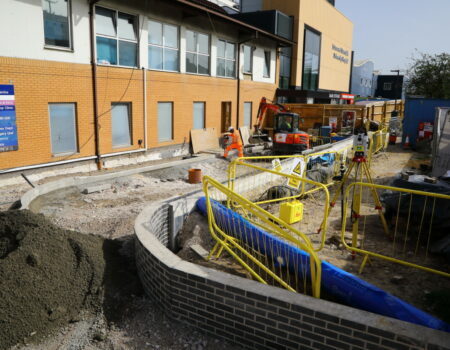 Emergency Department exterior construction with a high vis worker - Sep 2023