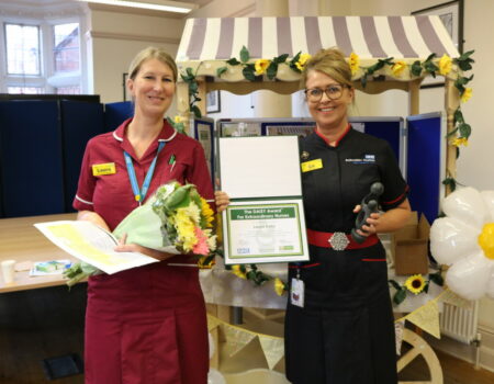 Laura receiving her certificate from Liz Lees