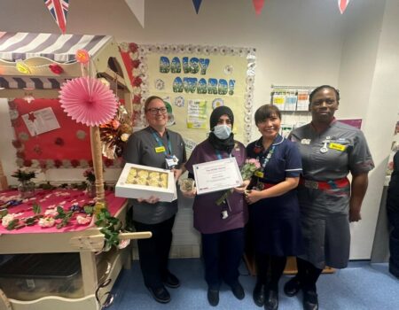 Mareen receiving her award from Louise, Ana, and Marva