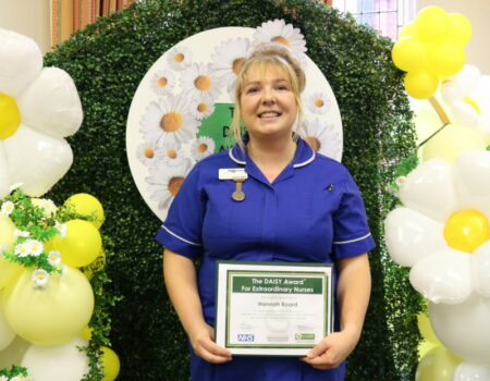 Hannah Board with her DAISY certificate