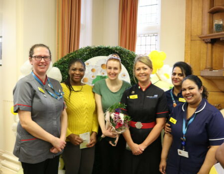 Leila with her DAISY bouquet with Liz, Helen, and colleagues