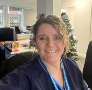 Sue Collins smiling at her desk