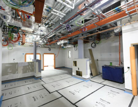 Acute Services floor being laid and ceiling wires in place - March 2024