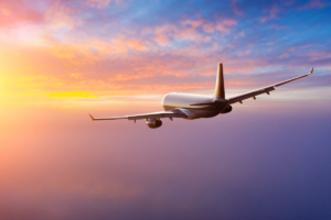 Plane flying at sunset