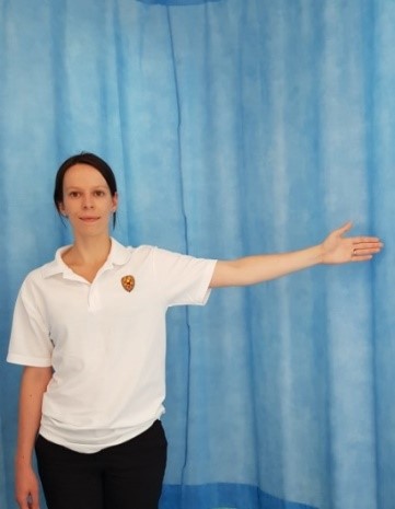 Person with arm out to the side, palm facing forward