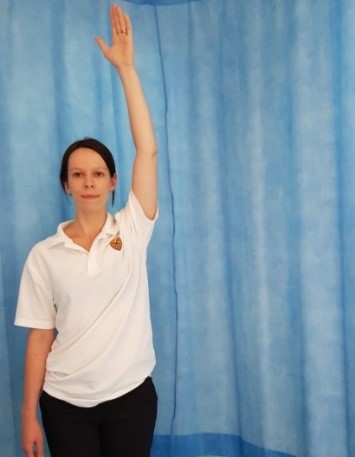 Person with arm extended upwards, palm facing forwards